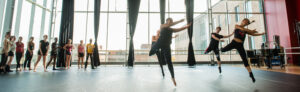 Image of dancers moving across the floor in the Dance Cube .